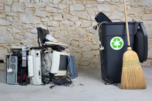 Empty commercial rubbish area with labeled recycling stations
