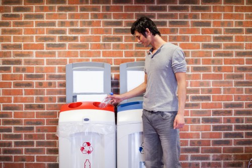 Low-carbon delivery van parked beside commercial recycling bins
